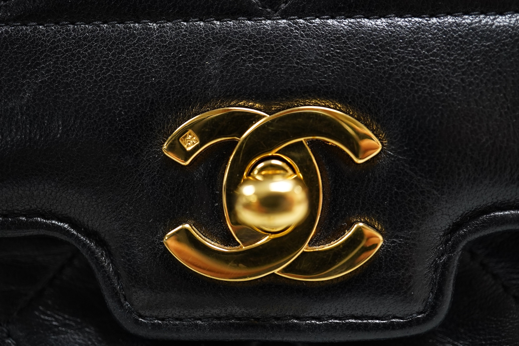 A late 1980’s Chanel black leather Diana shoulder bag with original dust cover and bag, Chanel authenticity card numbered 1944645, interior date code rubbed, 23cm wide, Provenance: Purchased by the vendor, 26 Old Bond St